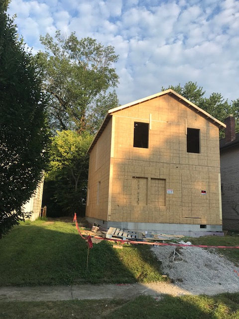 A house under construction with the number 77 on the side