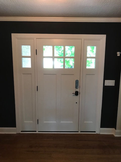 A white door with a black wall behind it