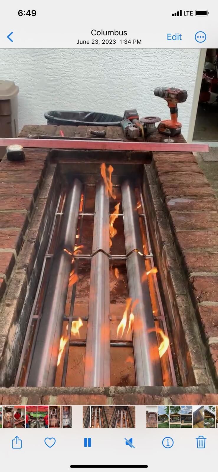 A picture of a fire coming out of a hole in a brick wall.