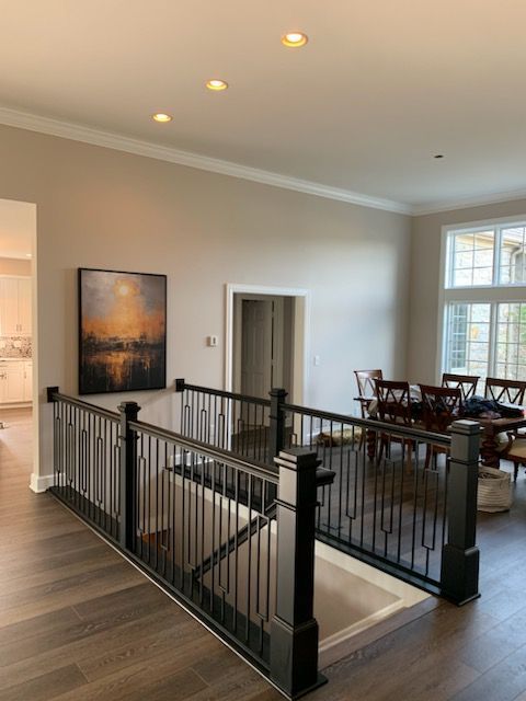 A staircase in a house with a painting on the wall above it