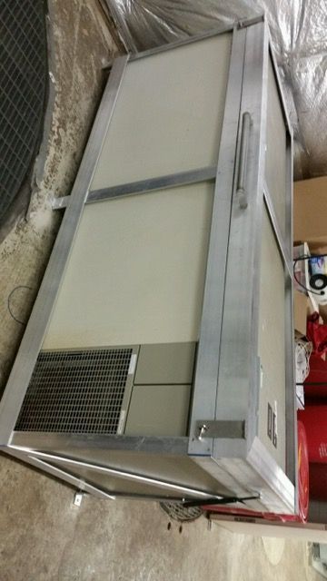 A white box is sitting on the floor next to a red box.