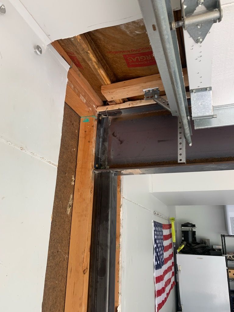 A picture of a garage door being installed in a house.
