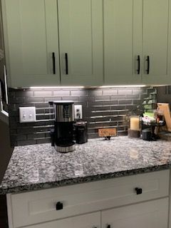 There is a coffee maker on the counter in the kitchen.