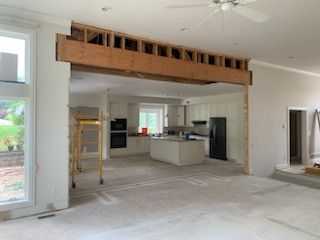 A kitchen and living room are being remodeled in a house.