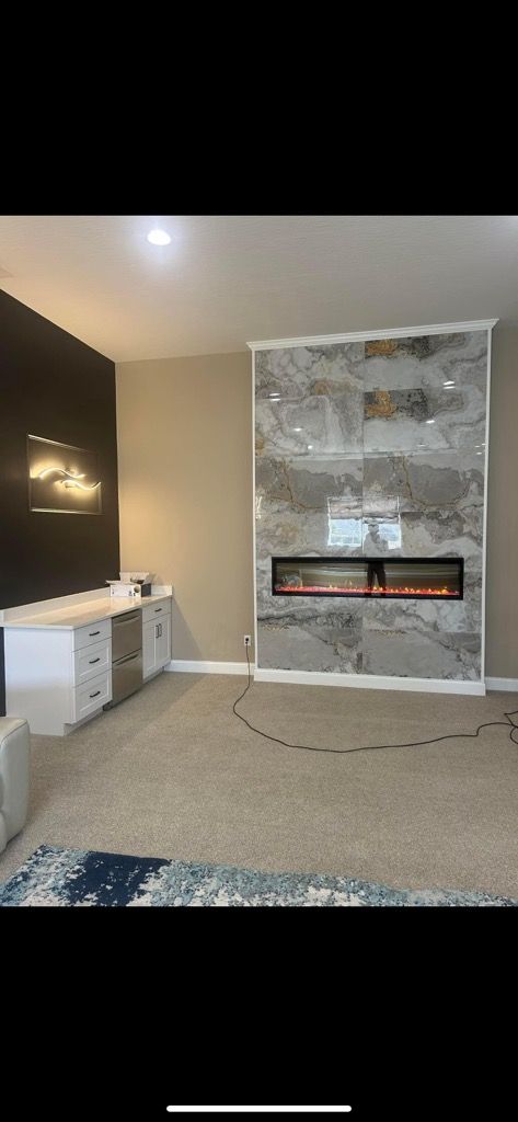 A living room with a fireplace and a flat screen tv.