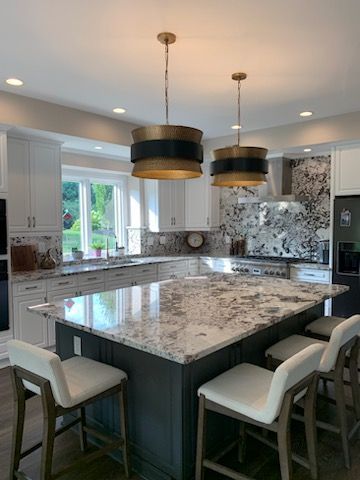There is a large island in the middle of the kitchen.