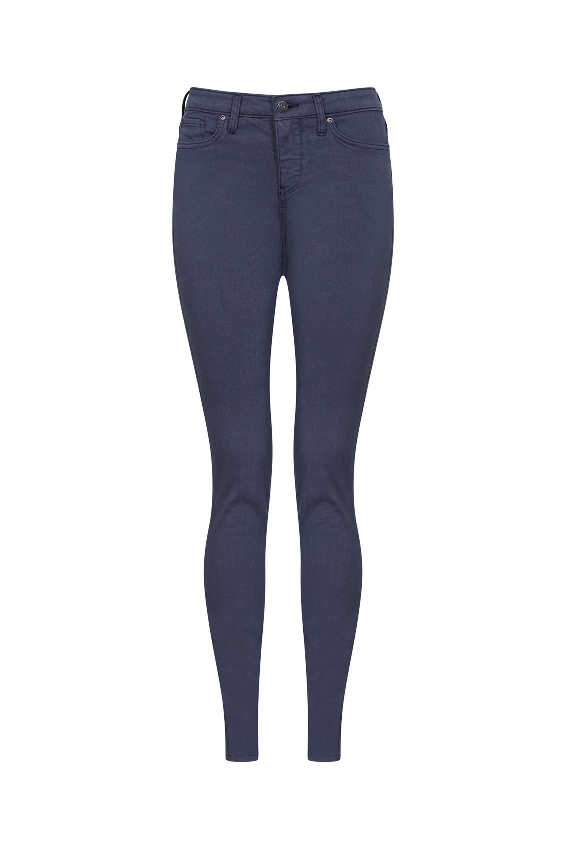 A pair of blue skinny jeans on a white background.