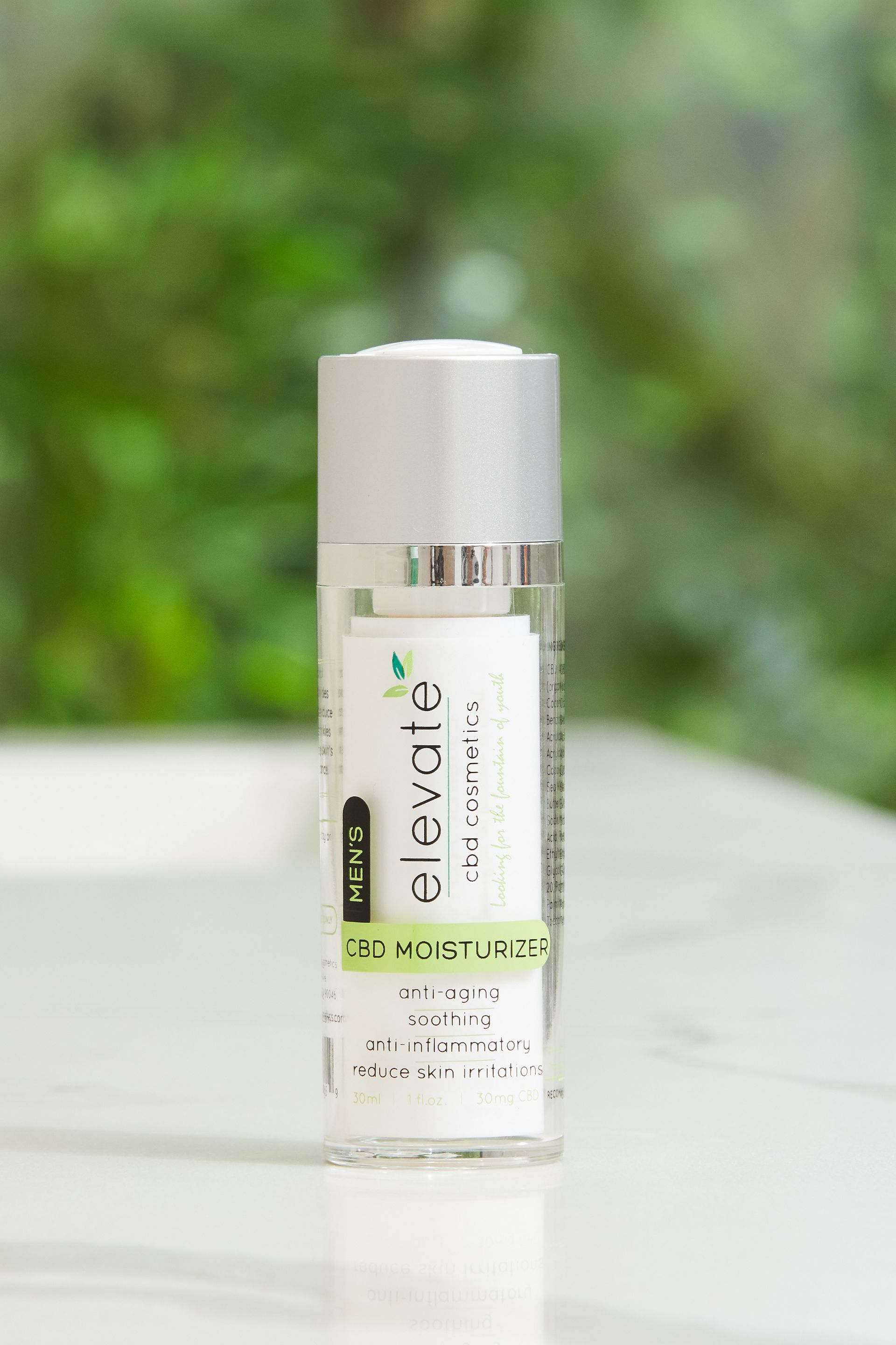 A bottle of lotion is sitting on a table.