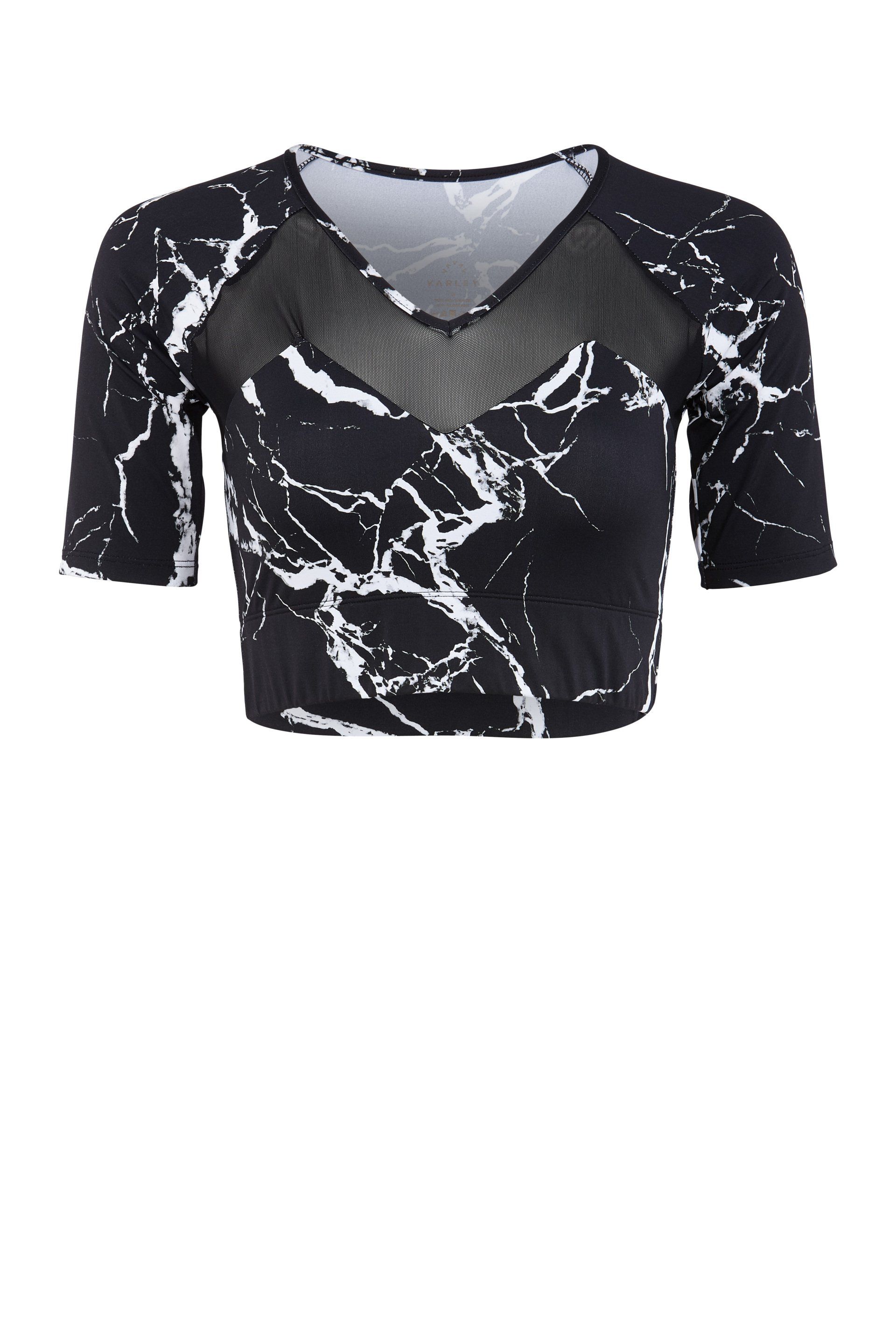 A black and white crop top with short sleeves and a mesh neckline on a white background.