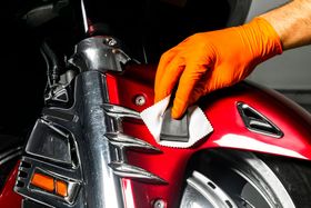 close up of washing and detailing a motorcycle
