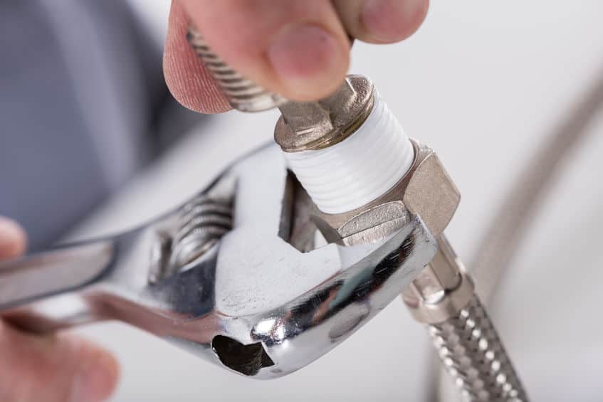 46185067 – plumber screwing plumbing fittings, closeup