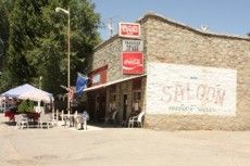 A saloon with a coca cola sign on the side of it.