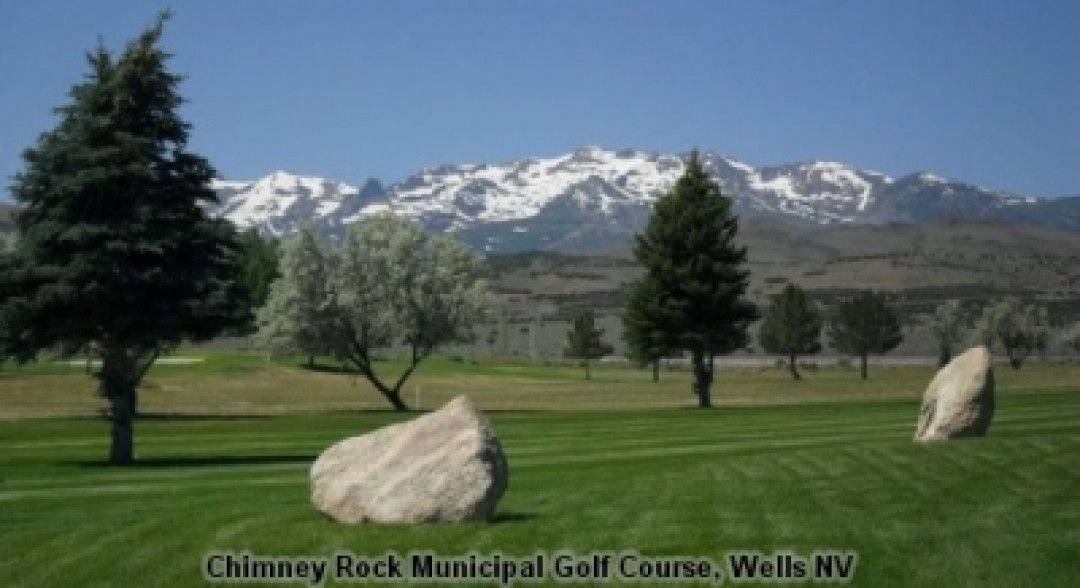 A picture of a golf course with mountains in the background