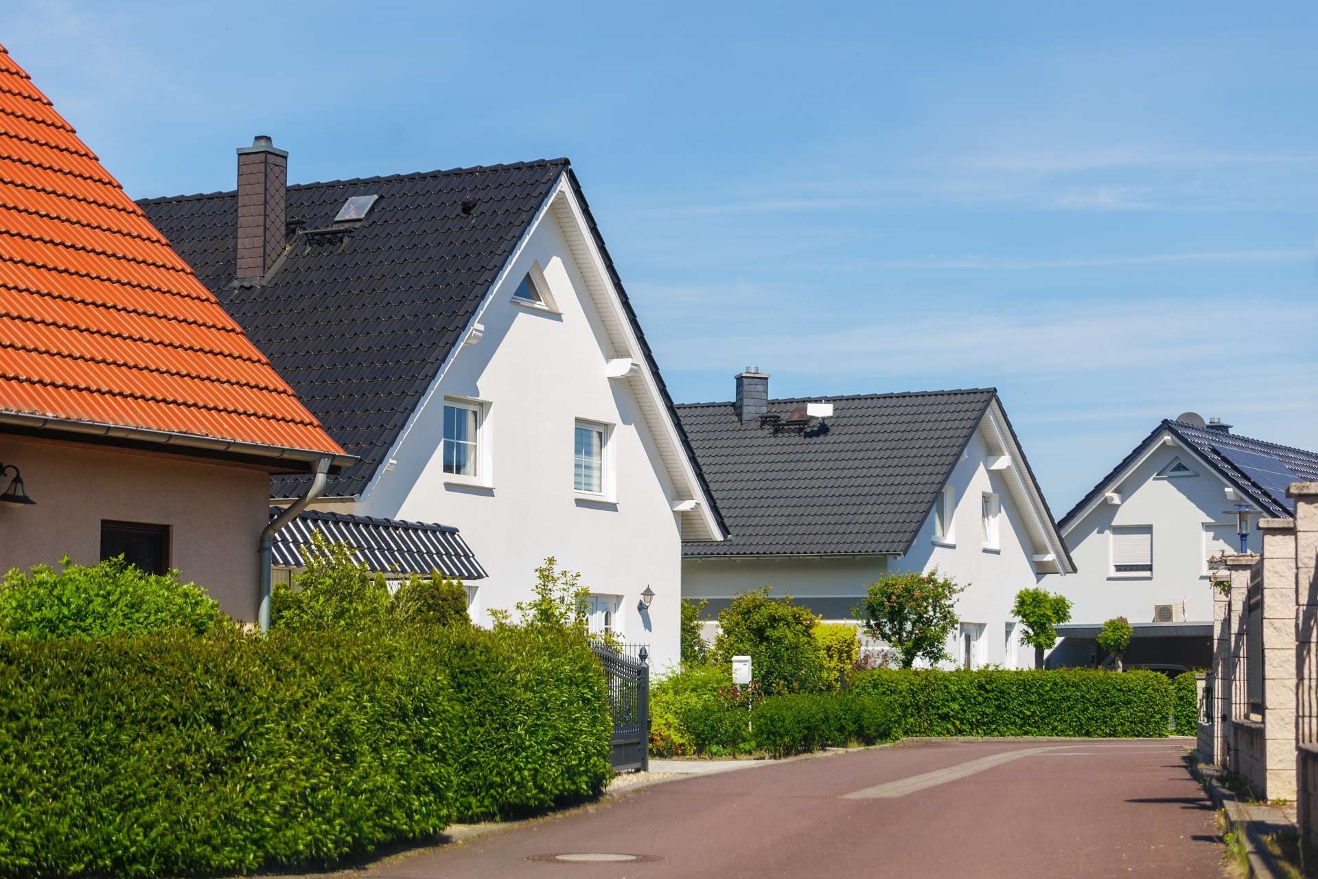 Row of houses with varying roof colors.