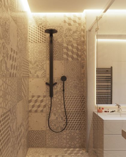 Shower with patterned tiles, black shower head, and adjacent vanity with a mirror and towel rack.