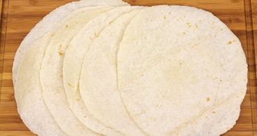 Soft flour tortillas on a cutting board