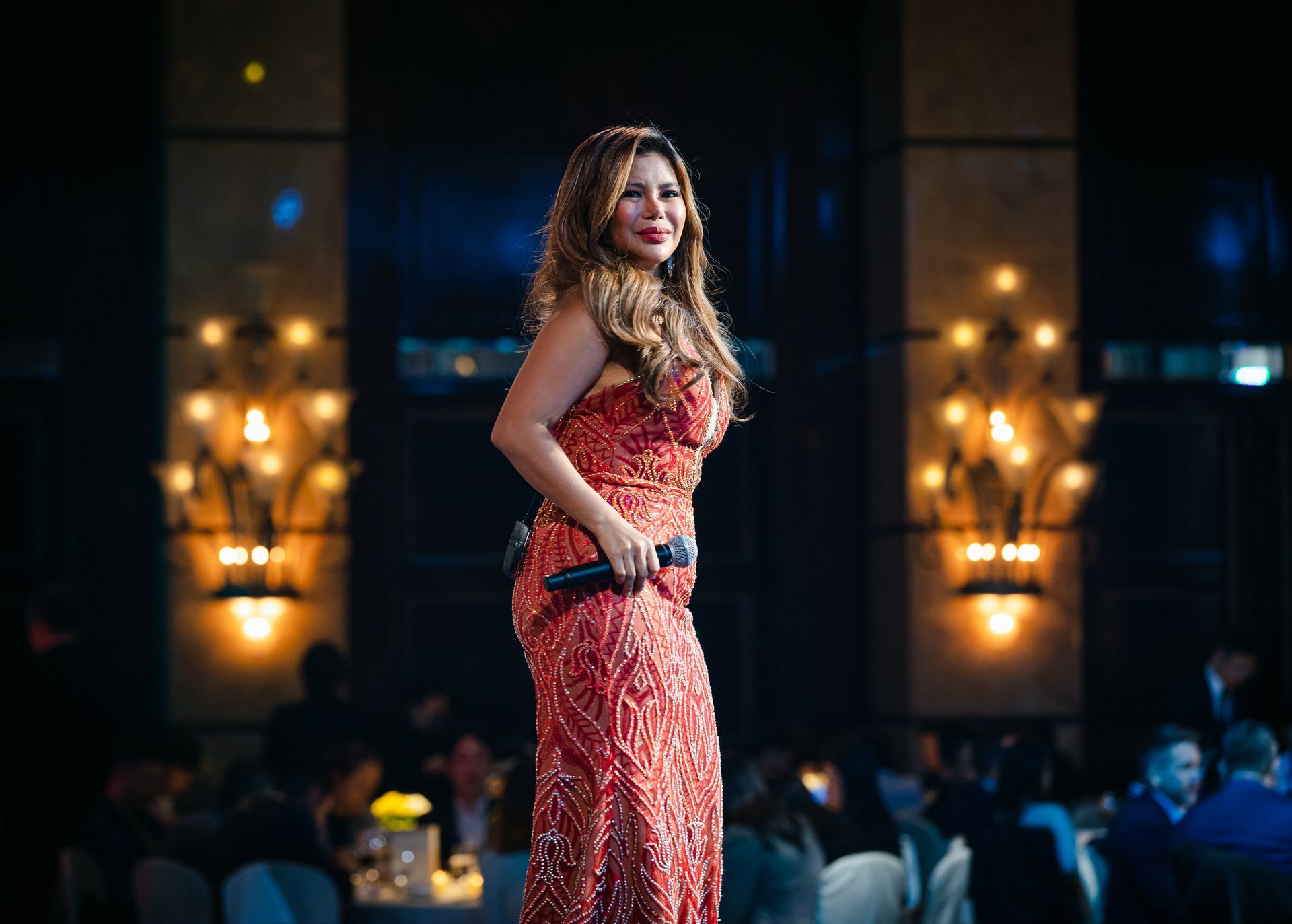 A photo taken by Ash Garwood of a woman performing at a corporate gala.