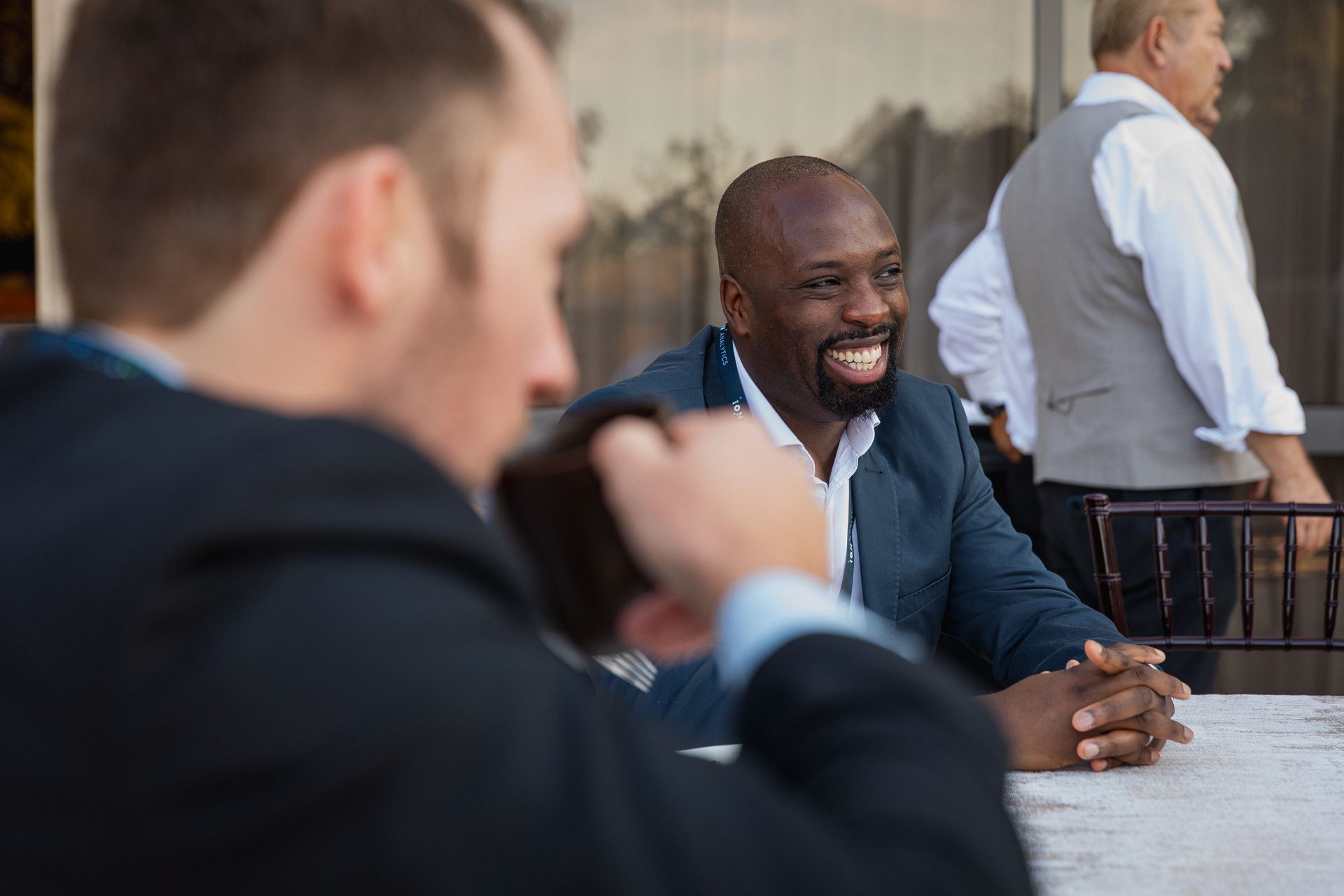 A photo taken by Ash Garwood of a man at a corporate meeting candidly talking with other delegates in Austin, Texas. 