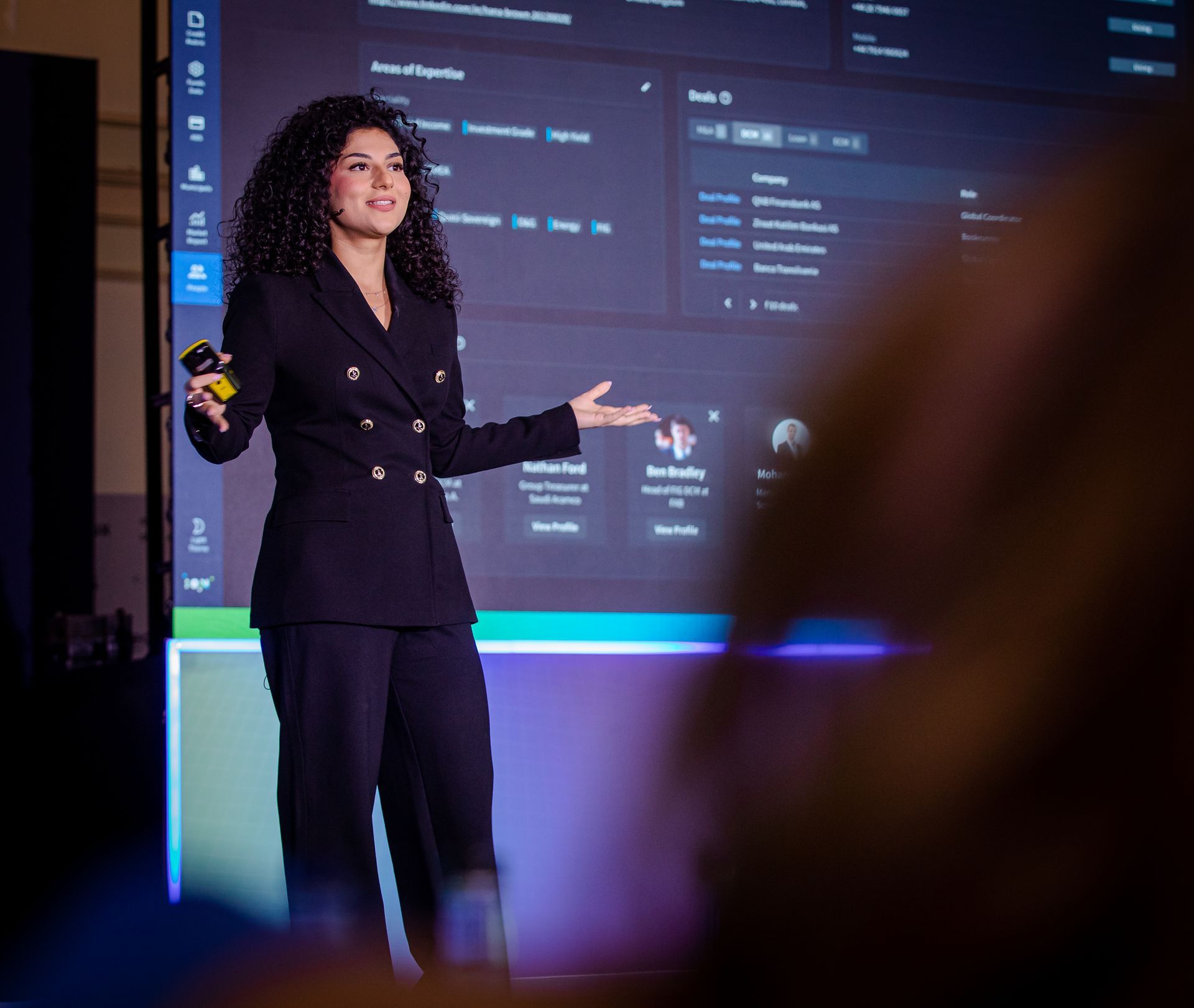 A photo taken by Ash Garwood of a woman presenting at a town-hall style corporate event.