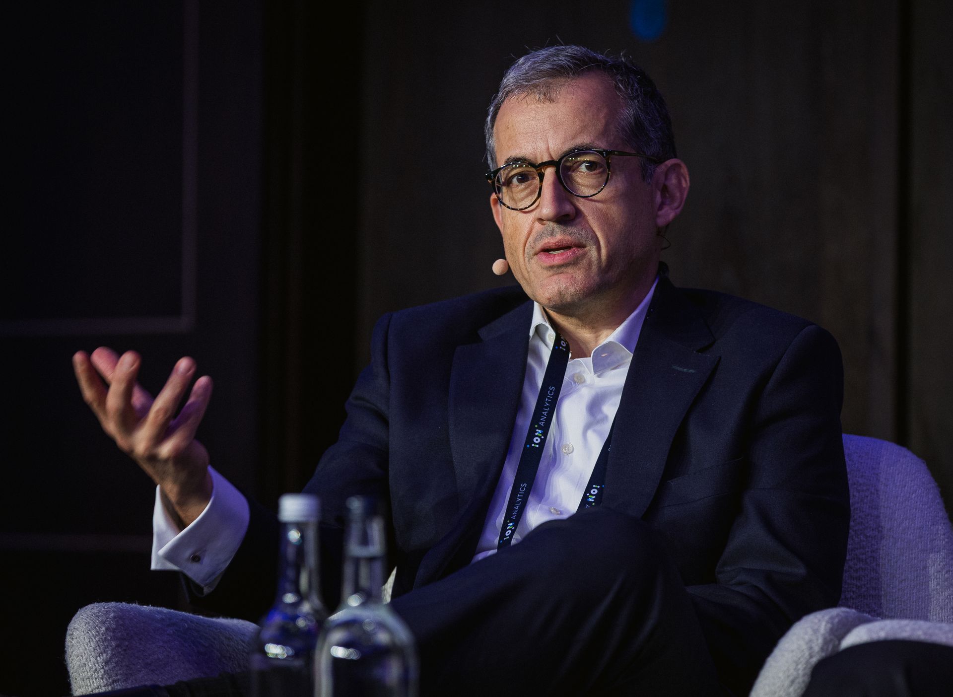 A photo taken by Ash Garwood of a man talking to a panel at a town-hall style corporate event.