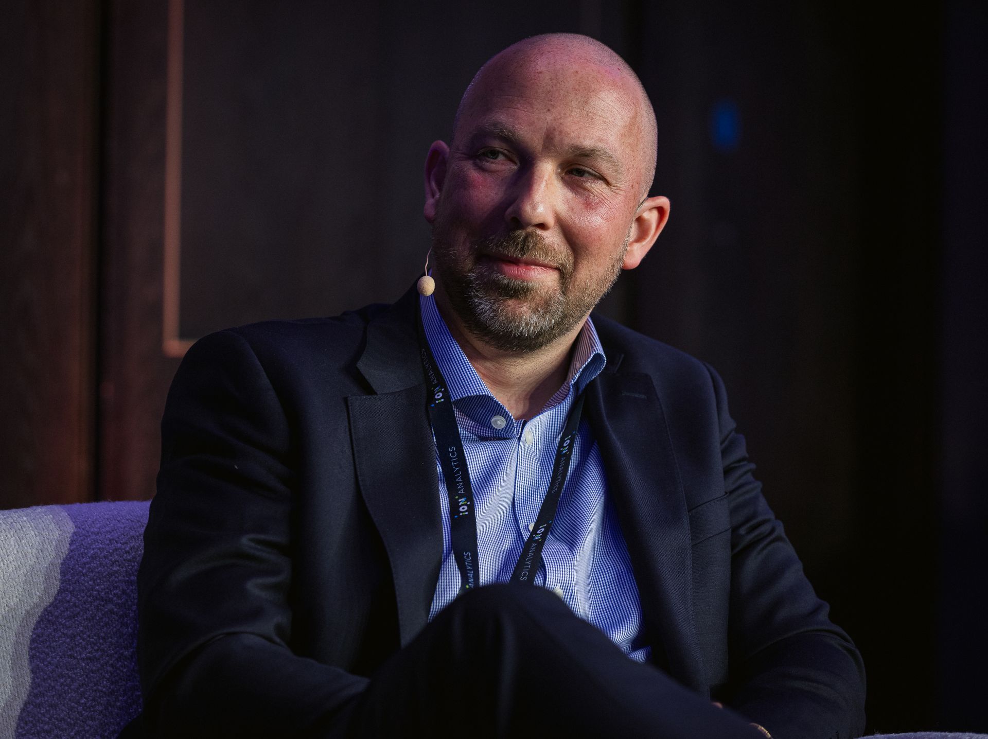 A photo taken by Ash Garwood of a man talking to a panel at a town-hall style corporate event.