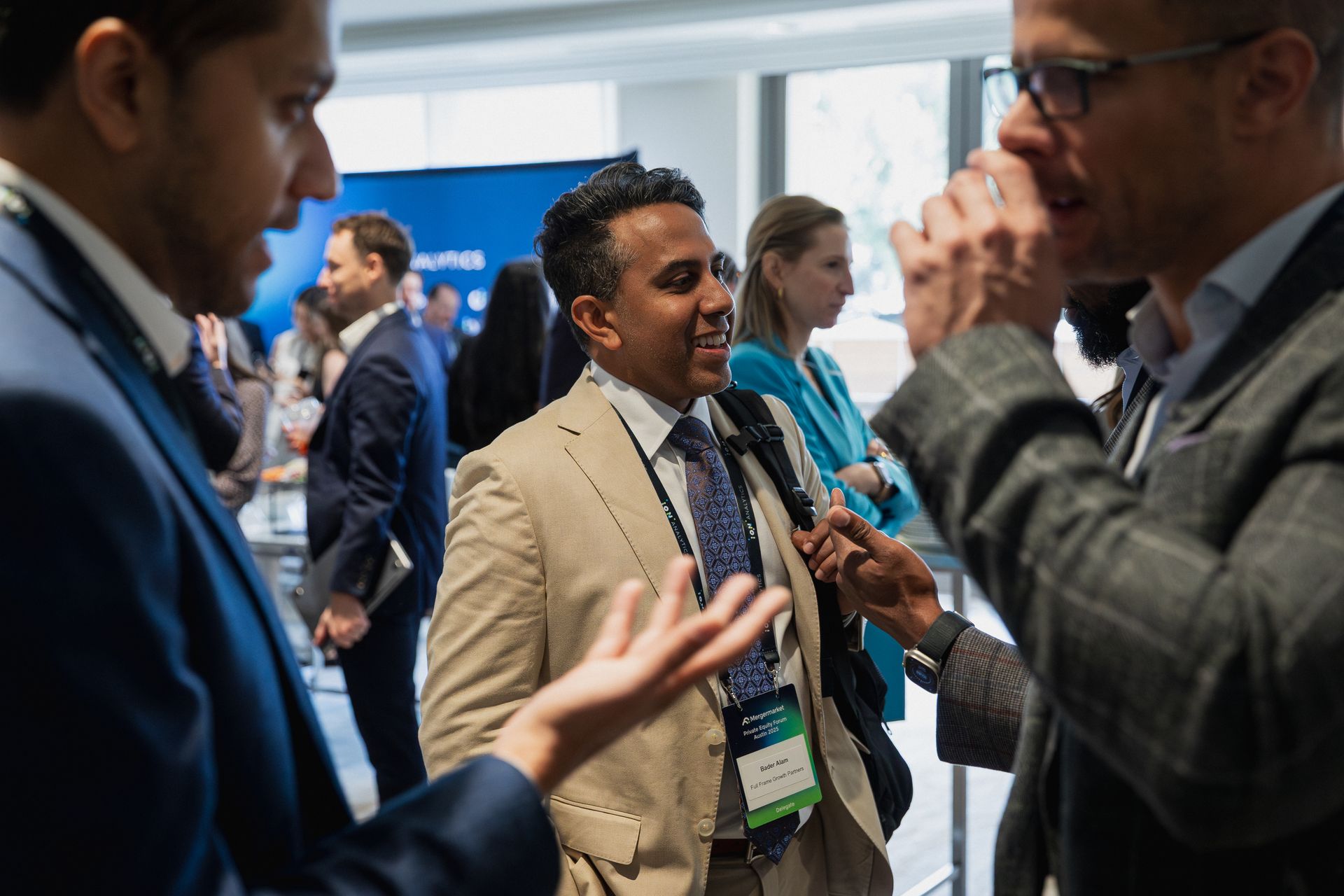 A photo taken by Ash Garwood of a man at a corporate meeting candidly talking with other delegates in Austin, Texas. 
