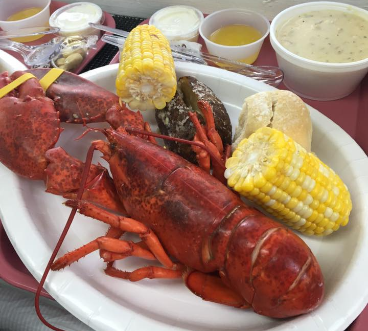 Steak, asparagus, and mashed potatoes on a white plate; wine glass and napkin in background.