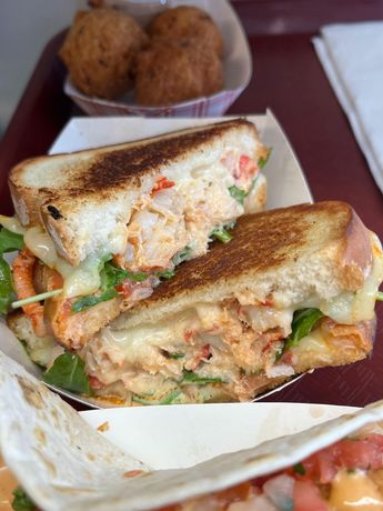 Lobster grilled cheese sandwich with arugula, two hushpuppies. Lobster grilled cheese sandwich with arugula, two hushpuppies.