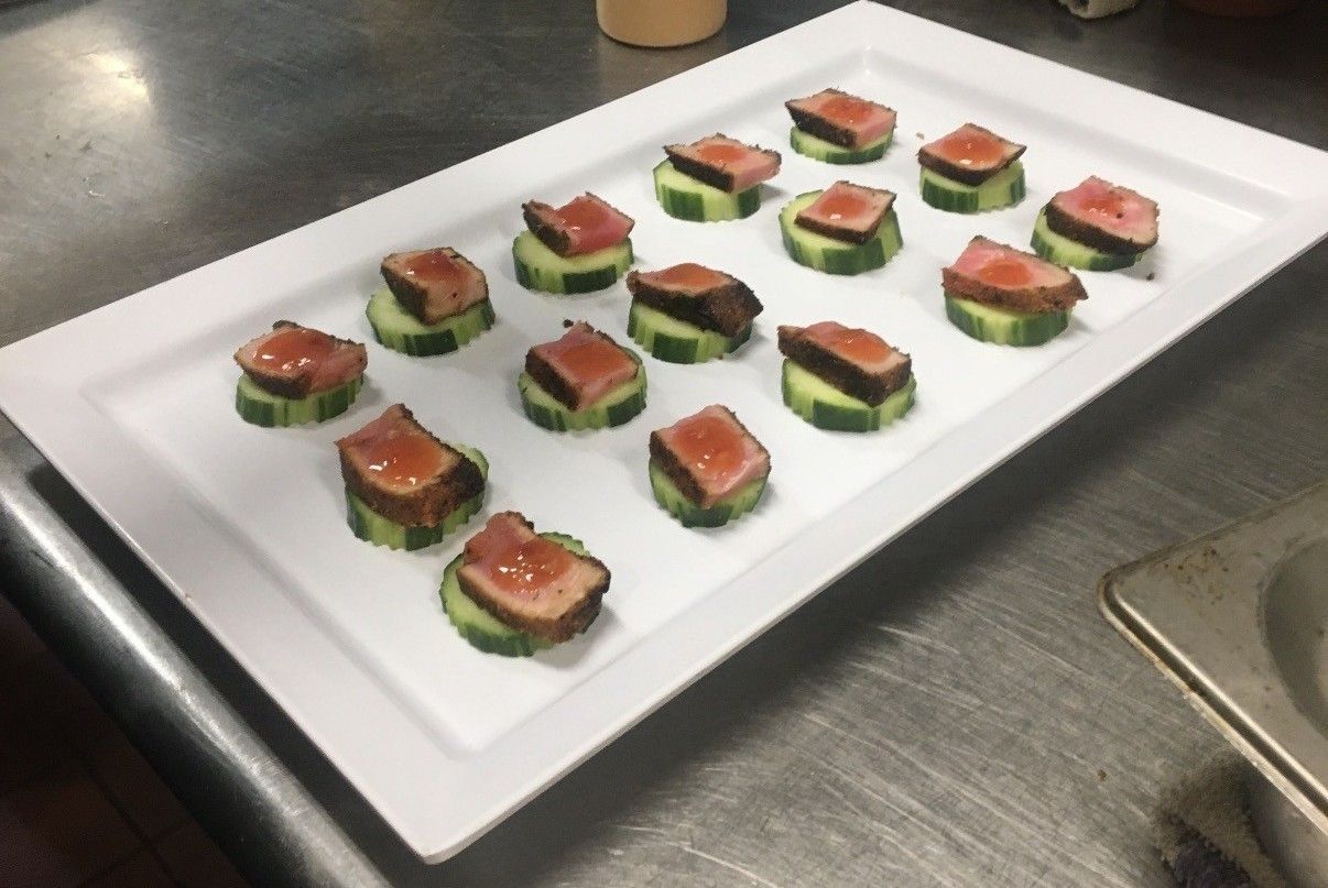 Chicken Caesar salad with grilled chicken, bacon, croutons, egg, and creamy dressing.