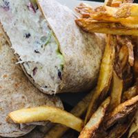 Wrap sandwich with coleslaw and french fries.