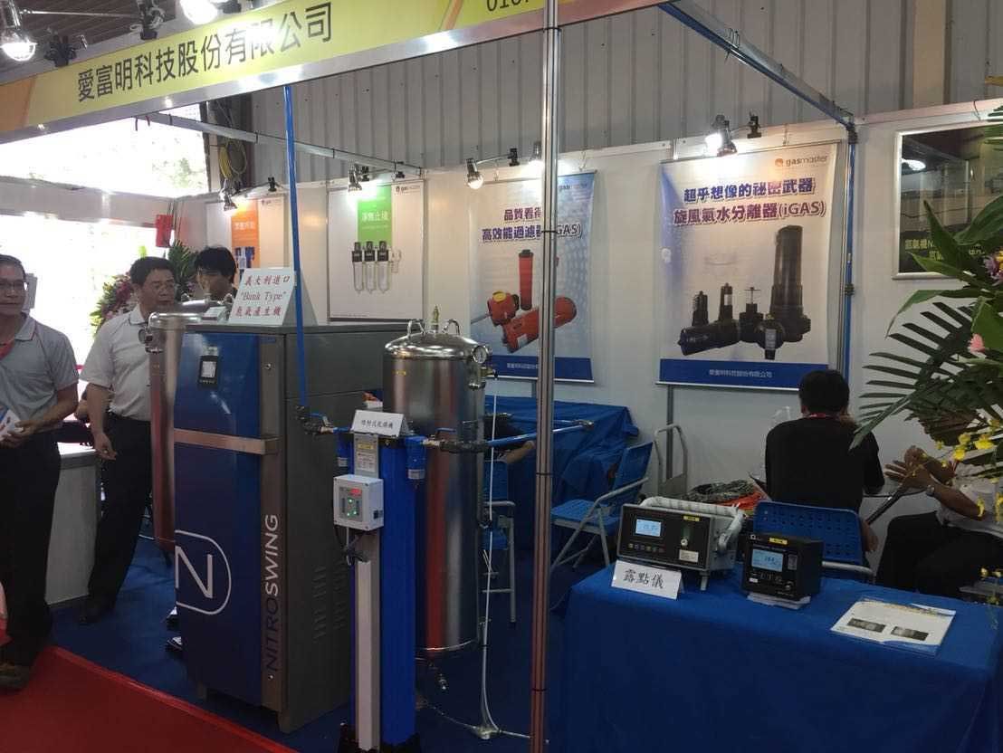 A group of people are standing around a booth at a trade show.