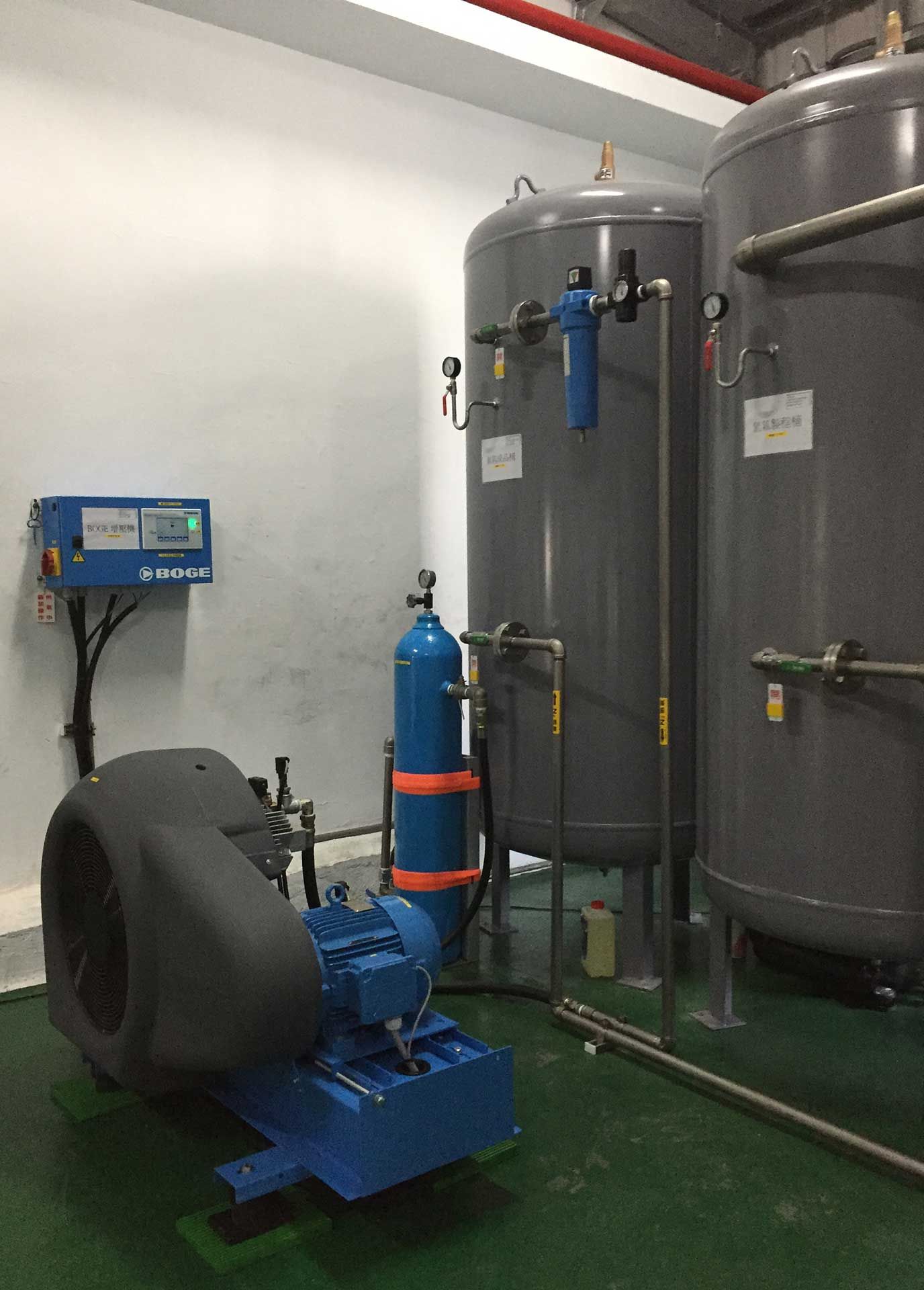 A room with a lot of tanks and a machine in it.