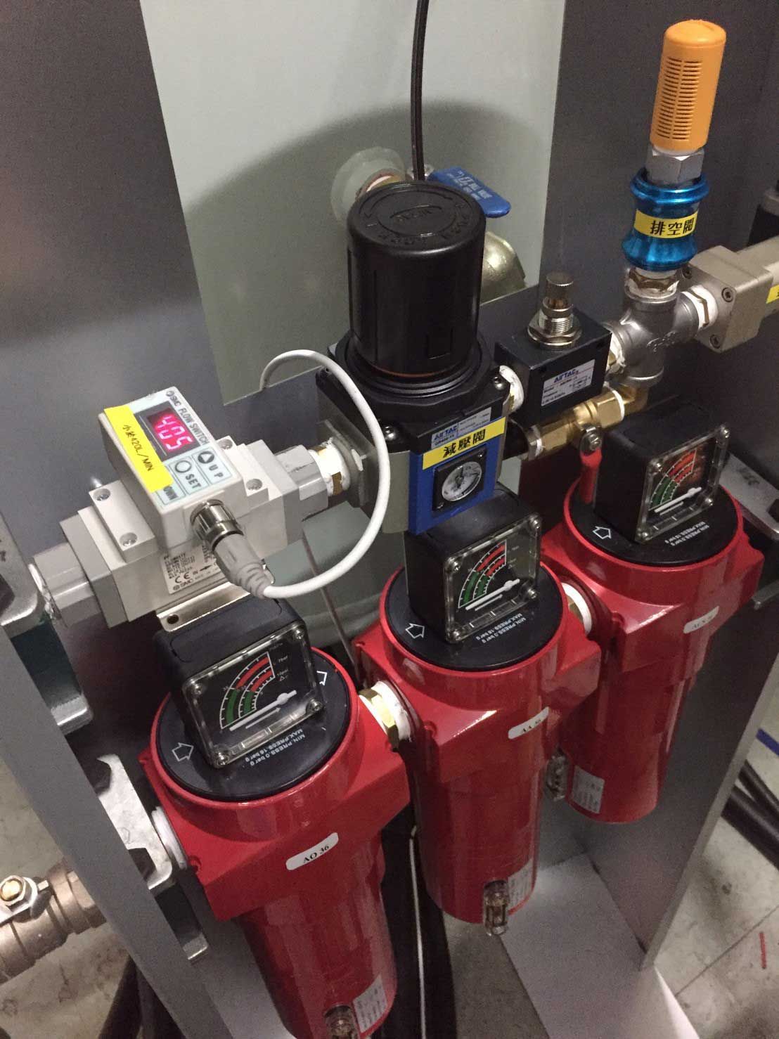 A row of red cylinders with a digital display on top of them.