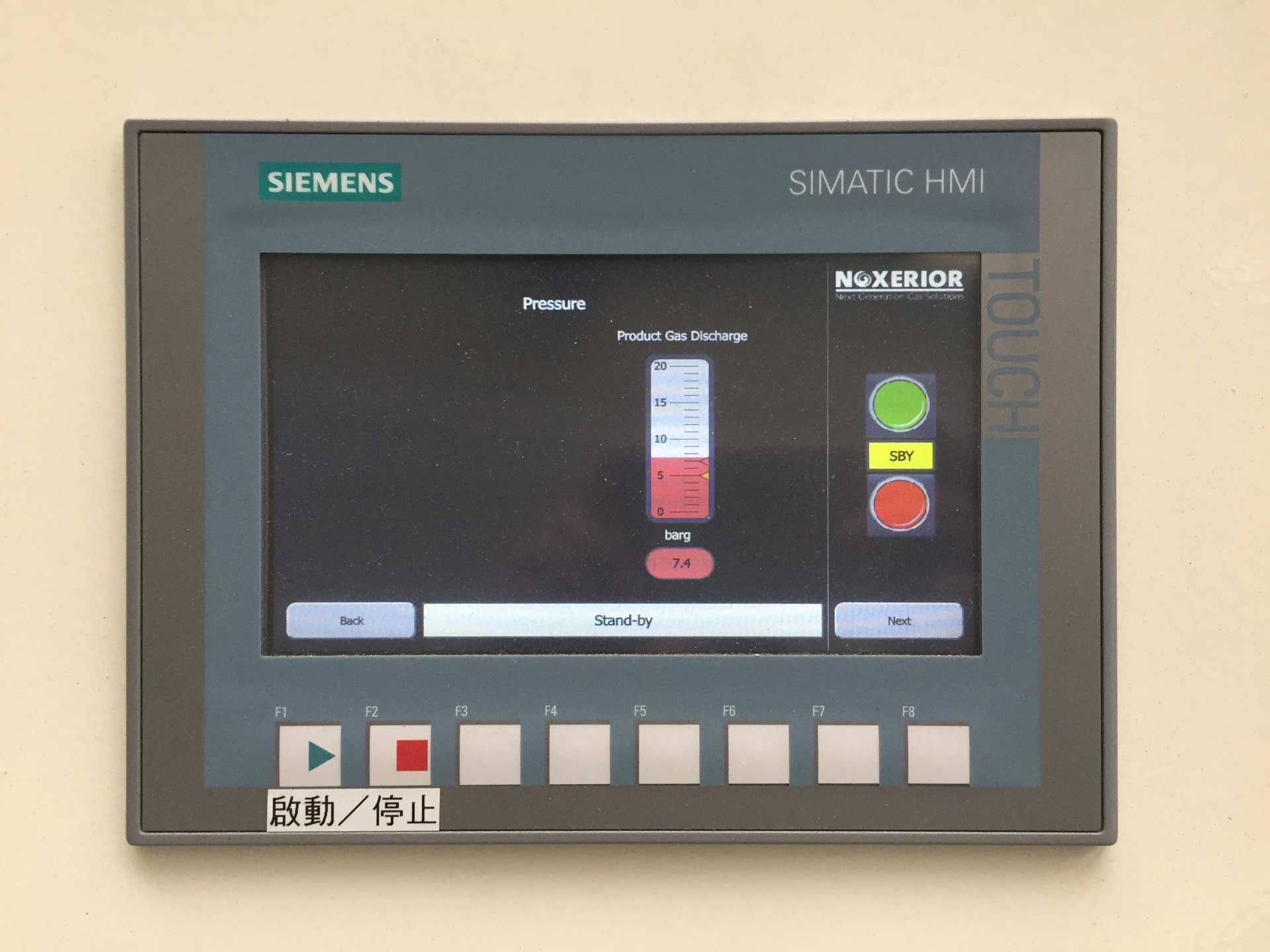 A siemens control panel is mounted on a wall