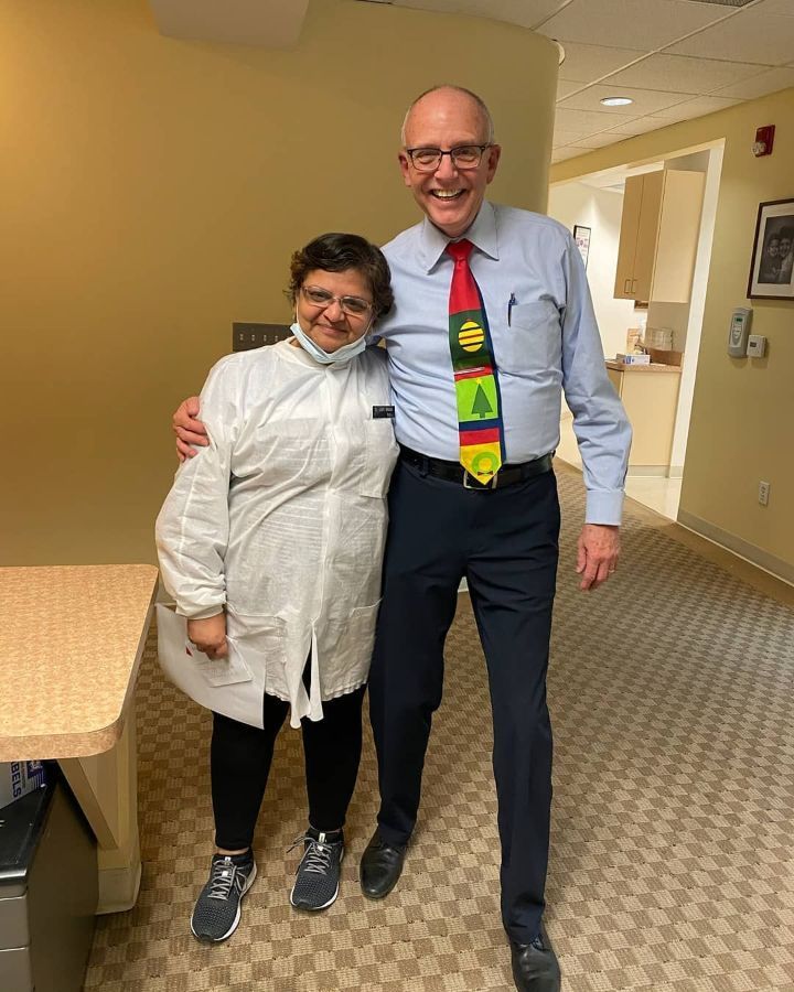 A man and a woman are standing next to each other in a hallway.