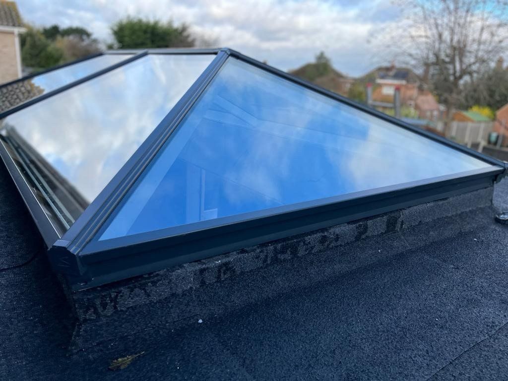 There is a skylight on the roof of a house.