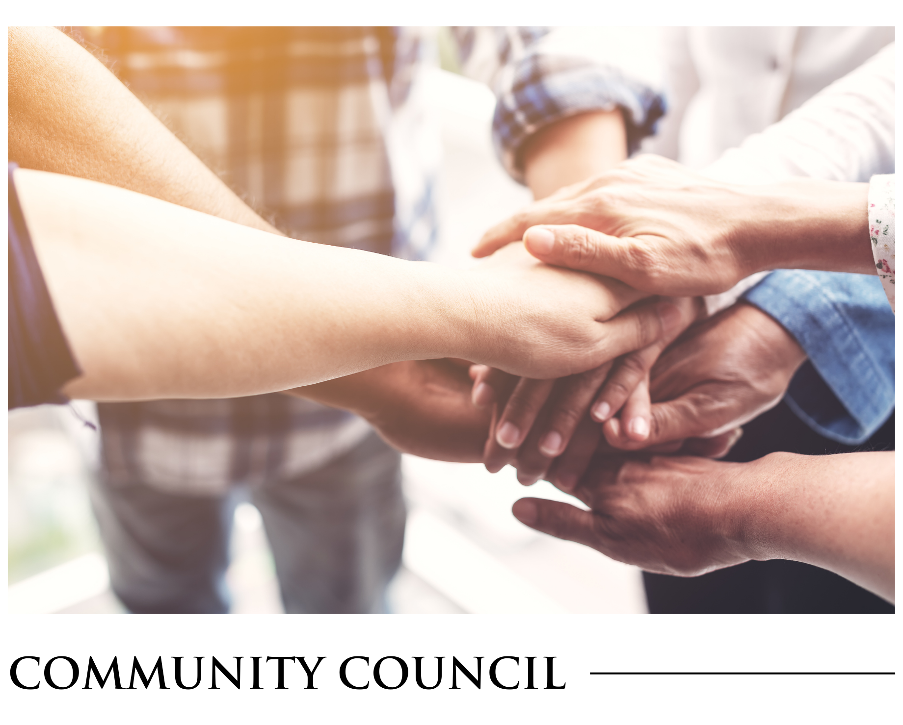 A group of people are putting their hands together.