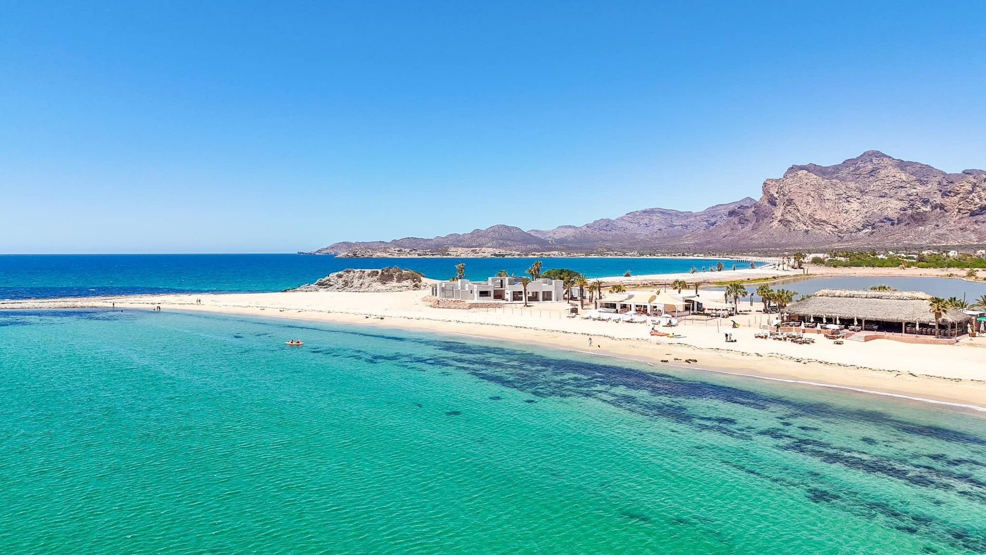Baseball game at Citi Field; batter swings at a pitch. Crowds fill the stands on a sunny day.