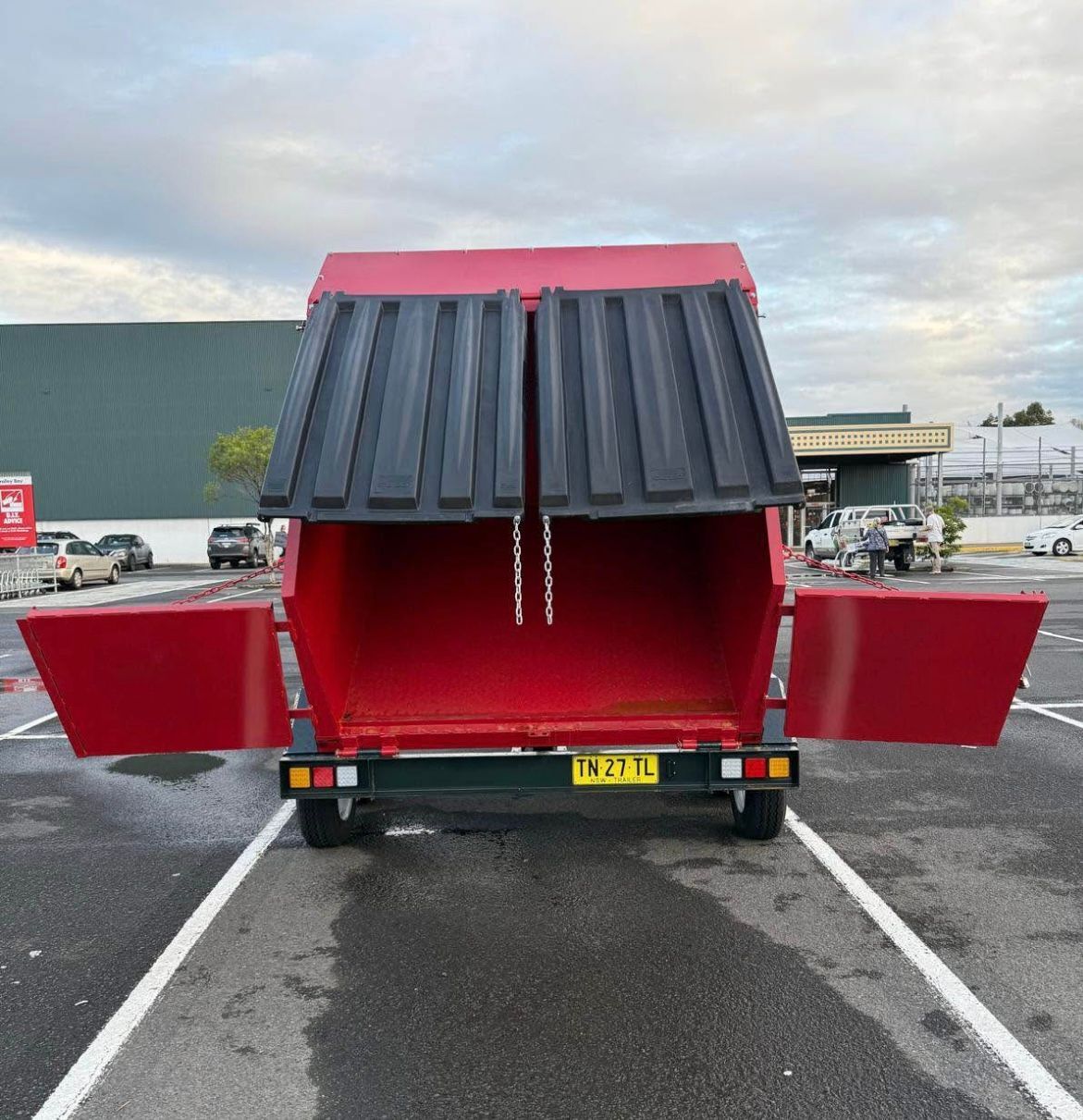 A Red Dumpster Trailer in Parking Lot— Trailer Trash Dubbo in Dubbo, NSW