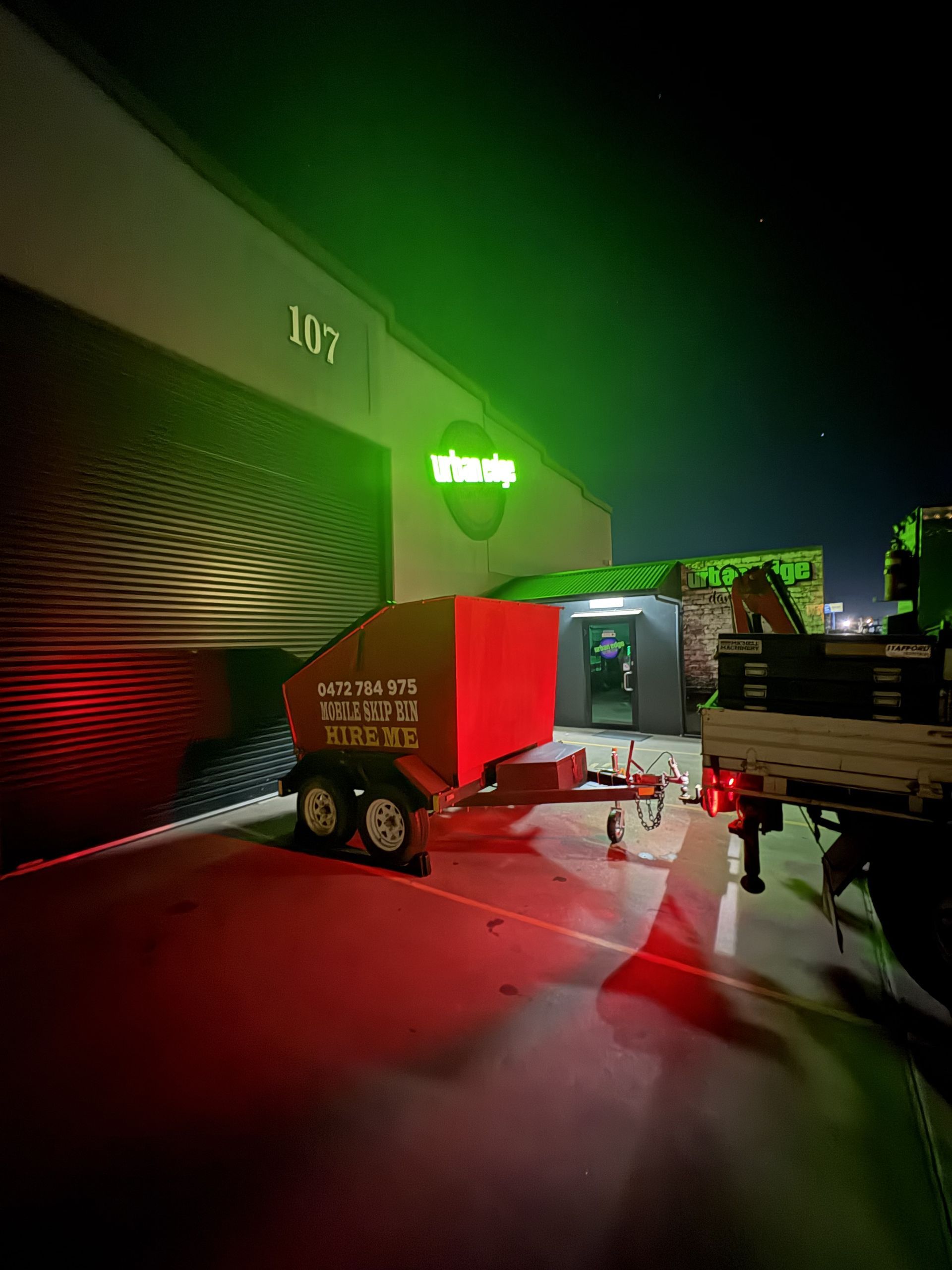 A Red Dumpster Trailer in Parking Lot at Night — Trailer Trash Dubbo in Dubbo, NSW