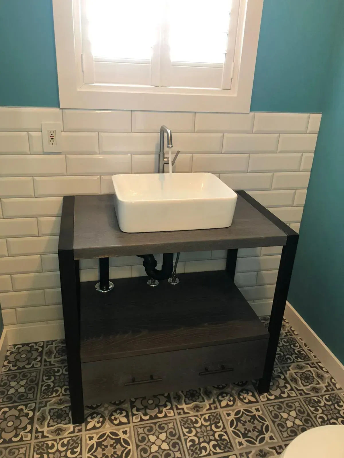 A bathroom with a sink and a window