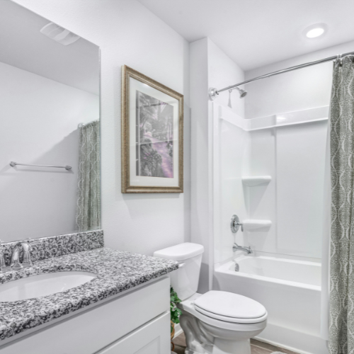 Bare feet walking forward on a wood floor near a window.