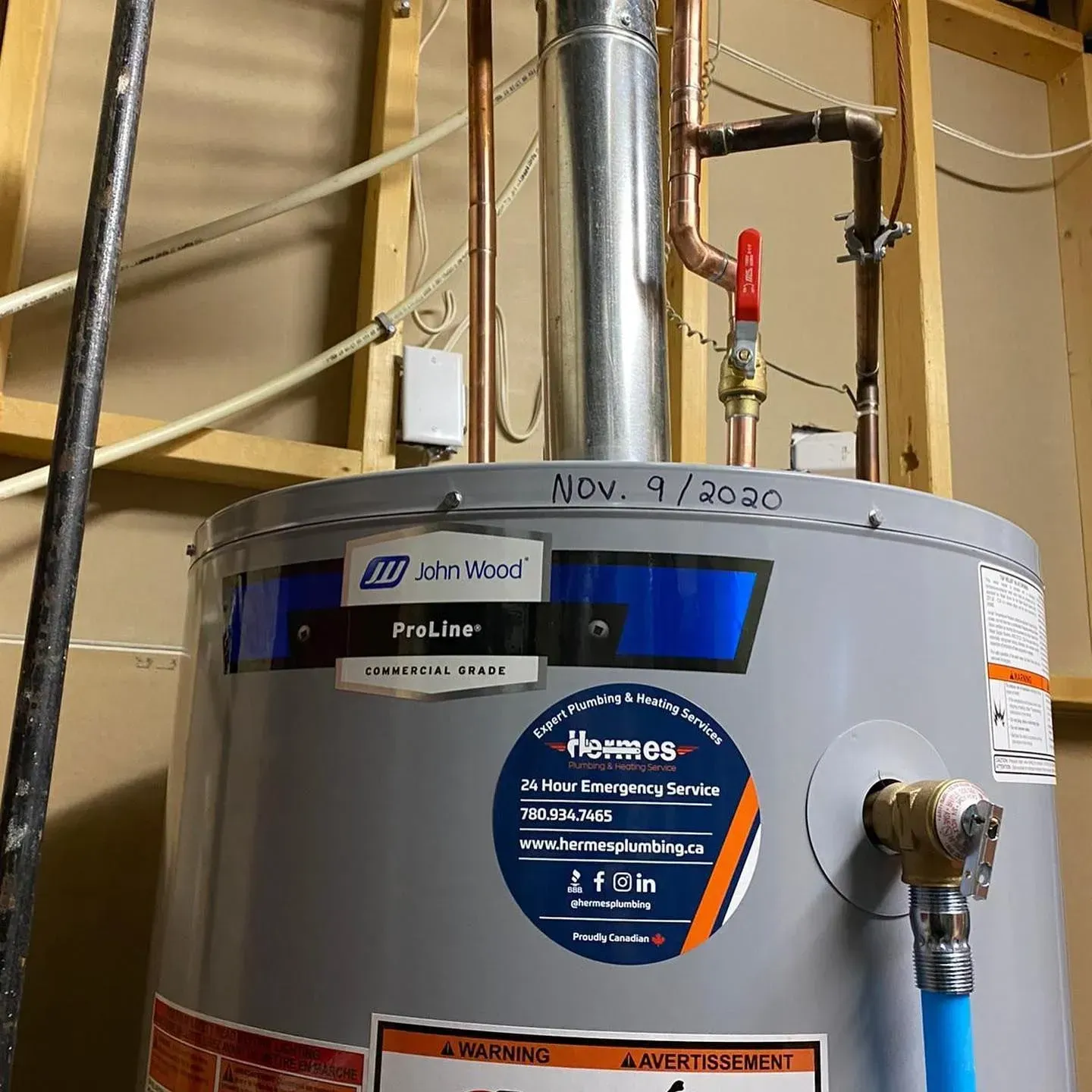 A water heater is sitting in a room next to a pipe.