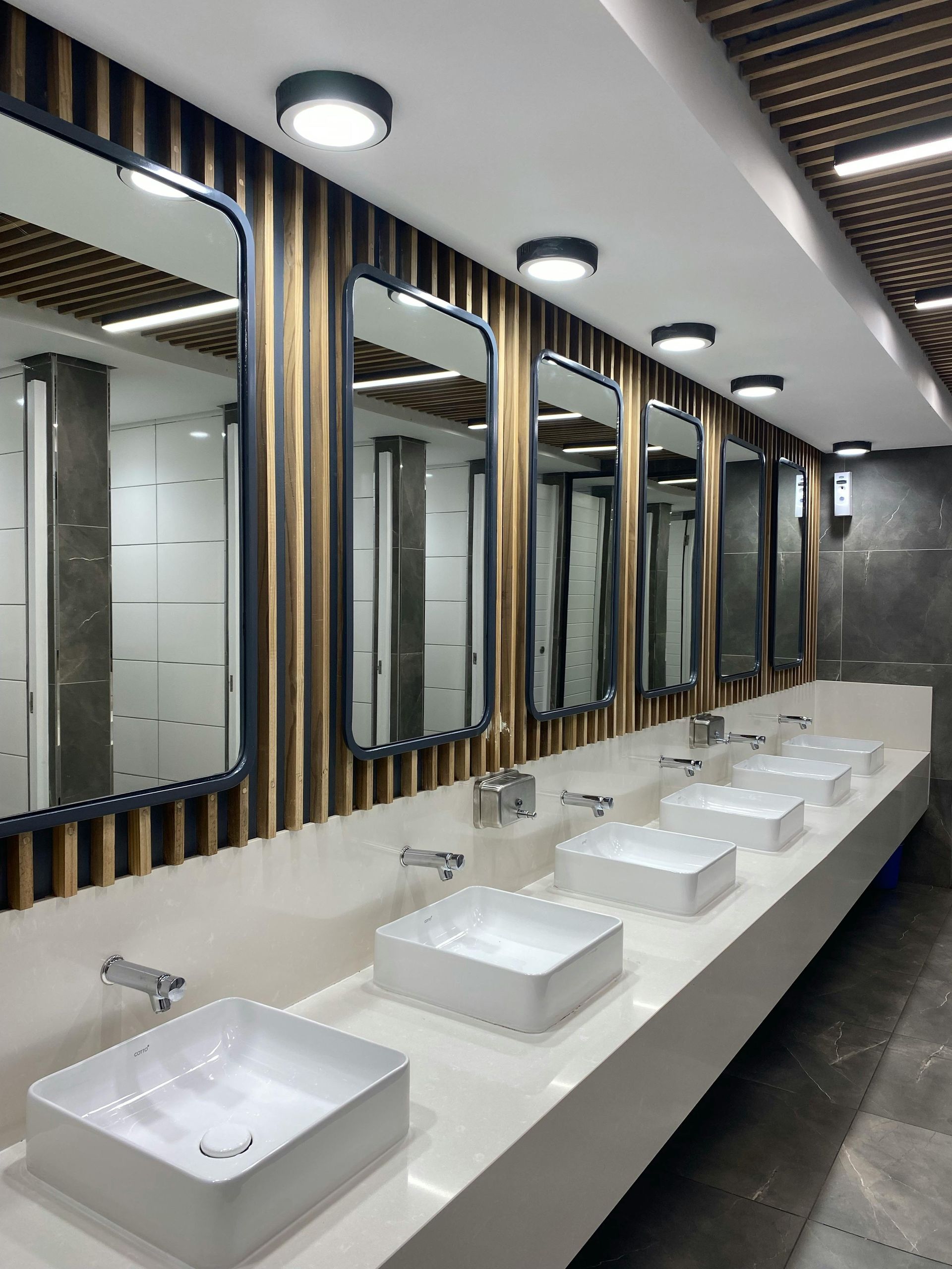A bathroom with two sinks and two mirrors