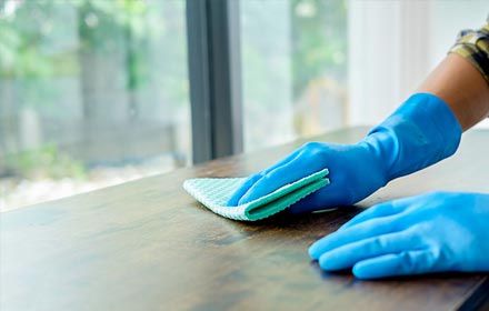 Cleaning Service concept. Cleaners employee removing dirt with equipment in office