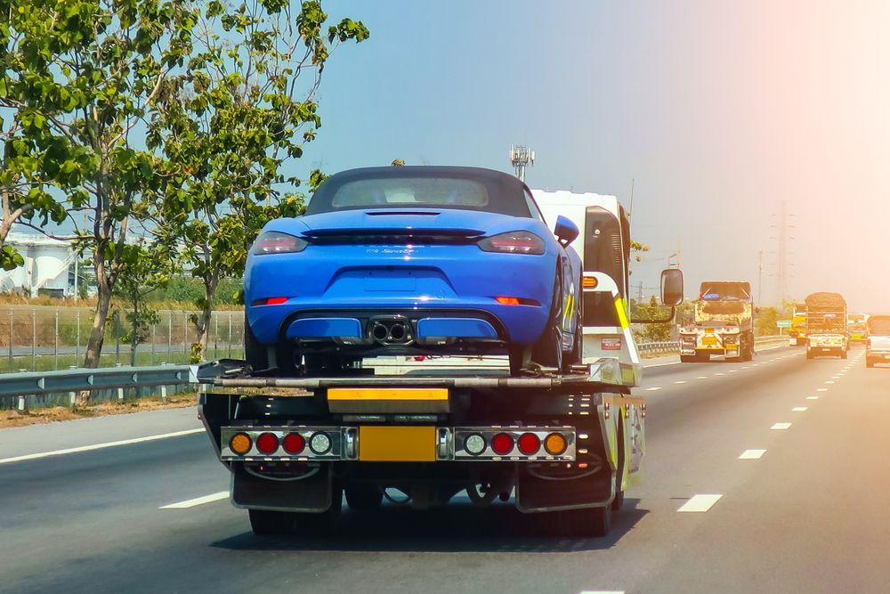 Blue Sports Car Being Towed Down By A Tow Truck — Tamworth Manual Transmission Factory In Tamworth, NSW