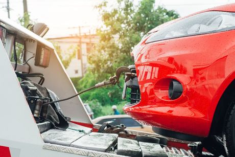 Red Car Is Being Towed By A Tow Truck — Tamworth Manual Transmission Factory In Taminda, NSW