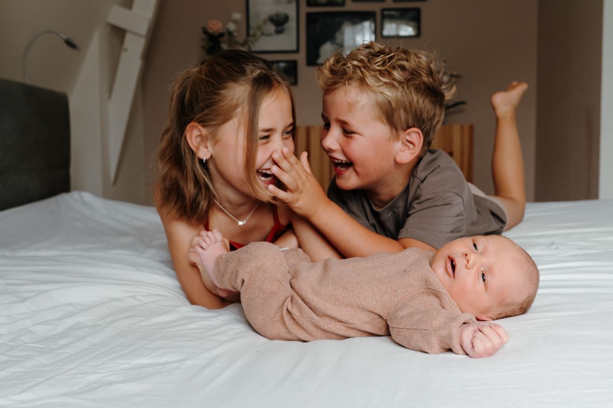 Newbornshoot aan huis, met zus en broer