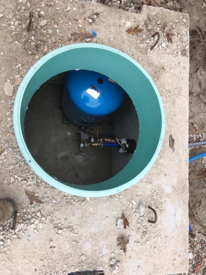 A blue tank is sitting inside of a green circle | Eldon, MO | Beanland Well Drilling & Pump Service
