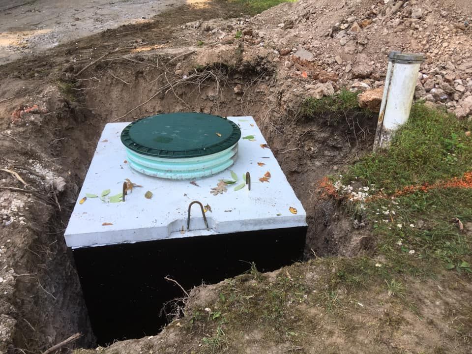 A septic tank is sitting in a hole in the ground | Eldon, MO | Beanland Well Drilling & Pump Service